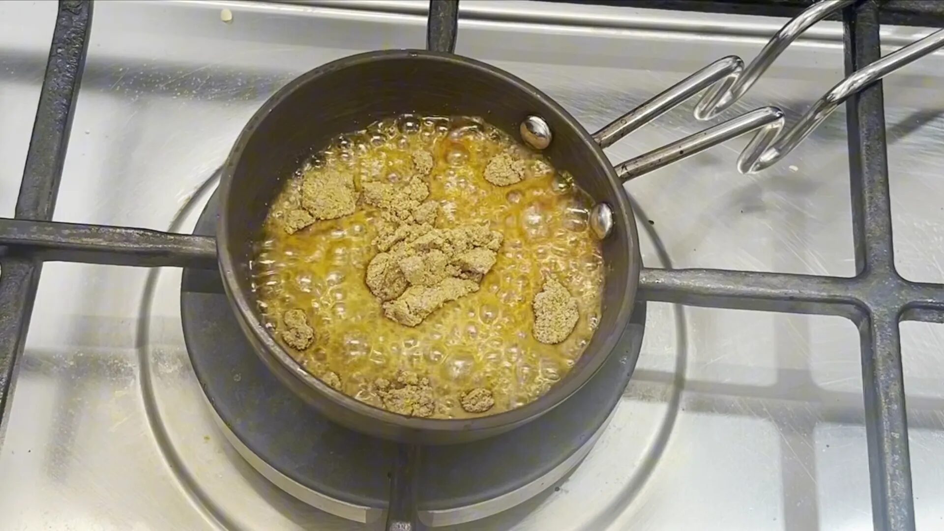 Adding spices to hot ghee for tempering